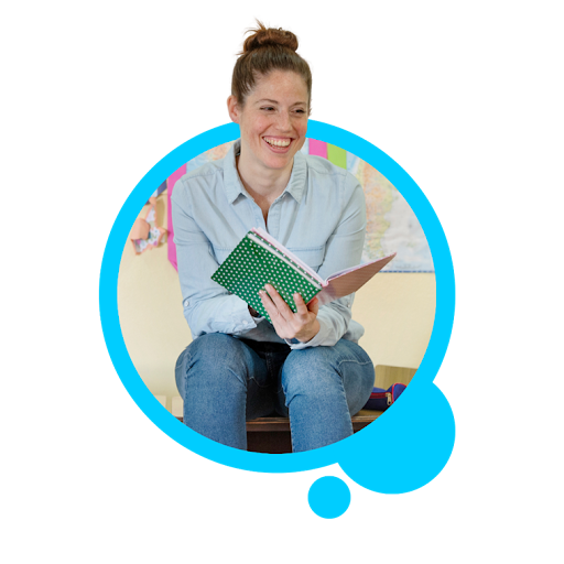 Female teacher smiling reading a book to a classroom
