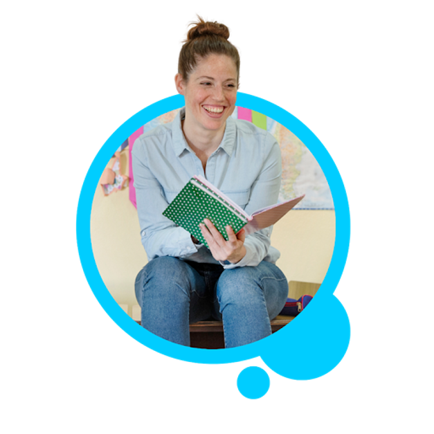 Female teacher smiling reading a book to a classroom